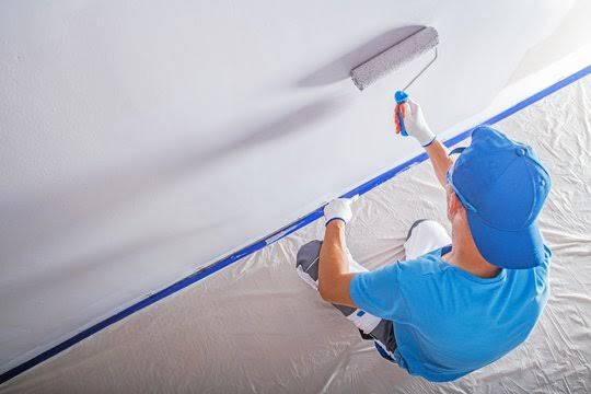 Interior ceiling painting with roller, taped and protected edges