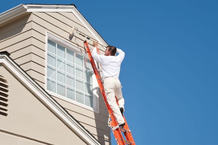 Painting exterior window trim from a ladder