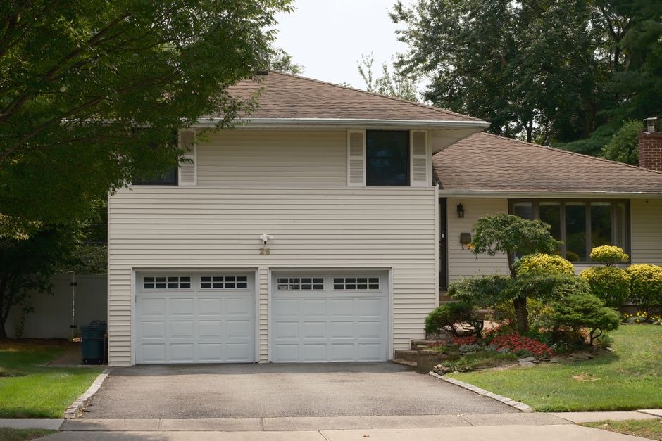 Charming suburban house featuring a double garage and lush garden.